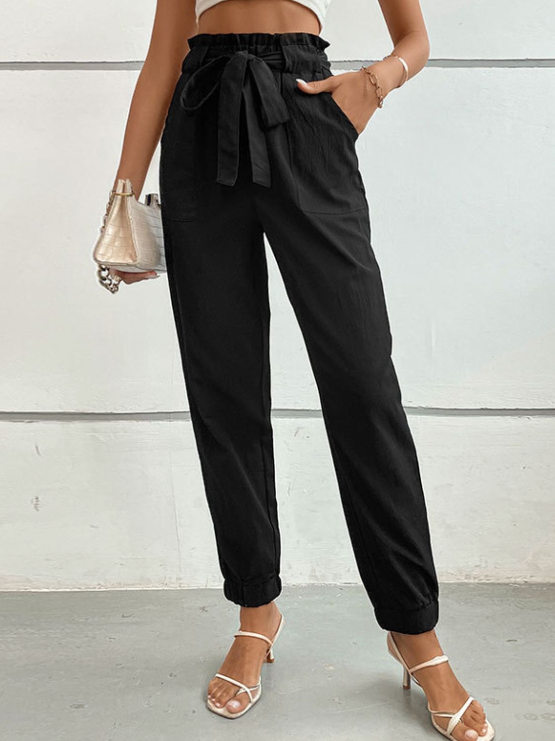 Black tie-front long jogger pants with elastic waistband and big bow at the waist