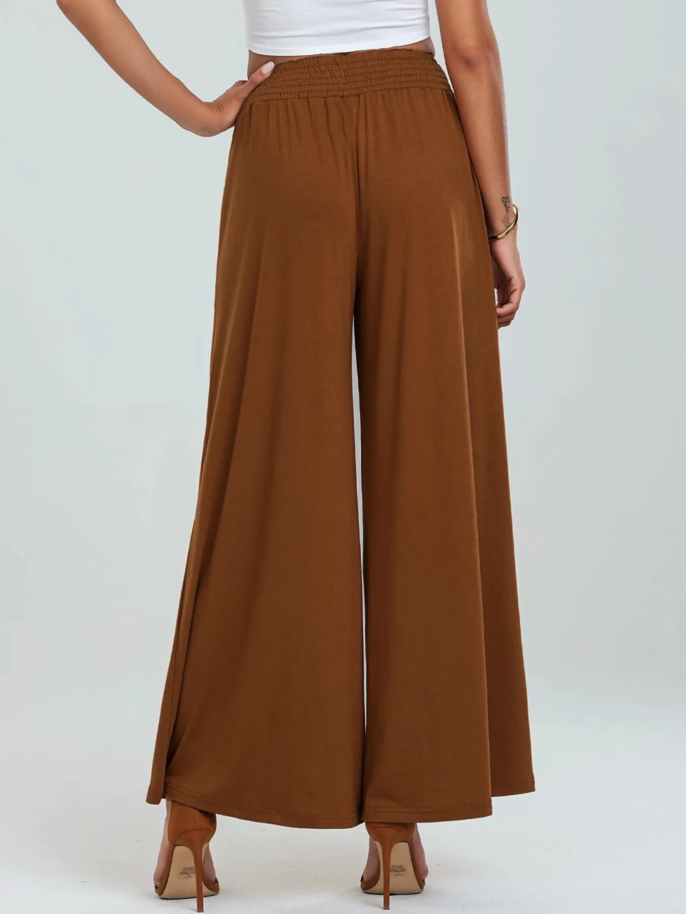 Brown high-waisted wide-leg pants with elastic waistband and side pockets
