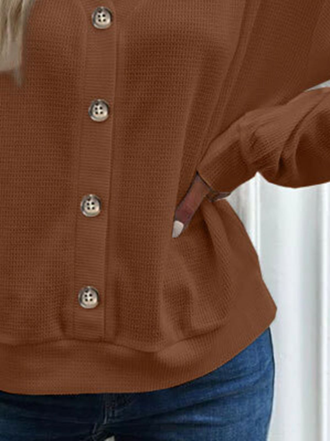 Caramel-brown blouse button placket and curved hem detail, long sleeves