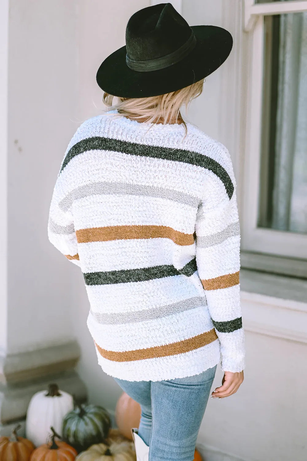 White striped sweater back view with green and tan horizontal bands and crew neckline