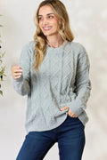 Dust sage cable knit round-neck sweater with long sleeves and ribbed cuffs