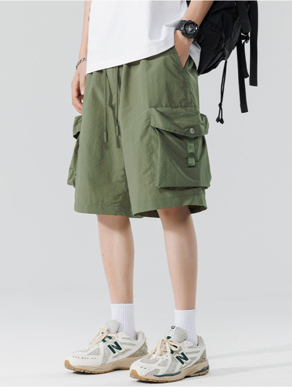 Men's relaxed cargo shorts in military green with flap cargo pockets and drawstring waist