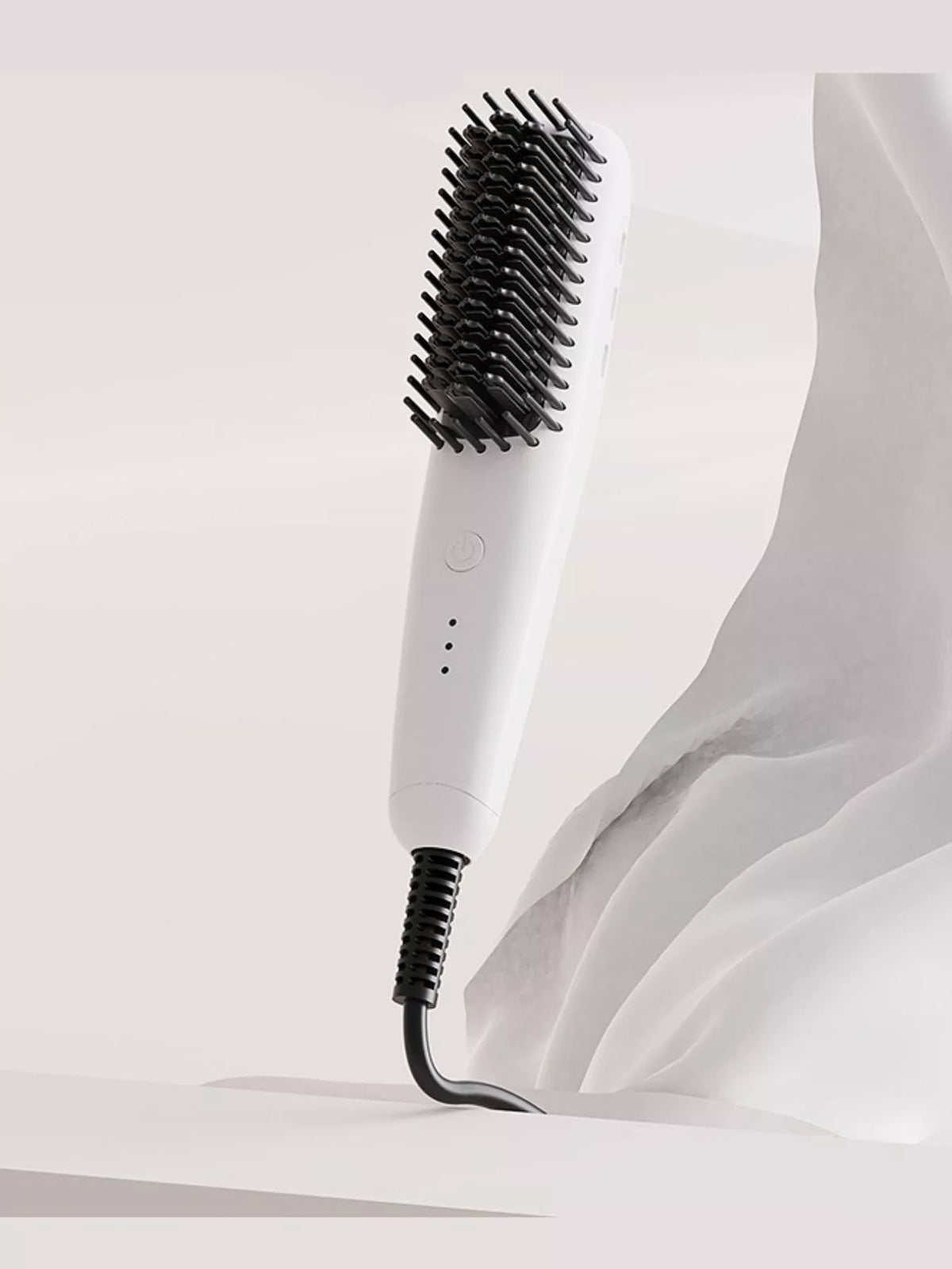 White heated straightening comb with black bristles and corded handle.