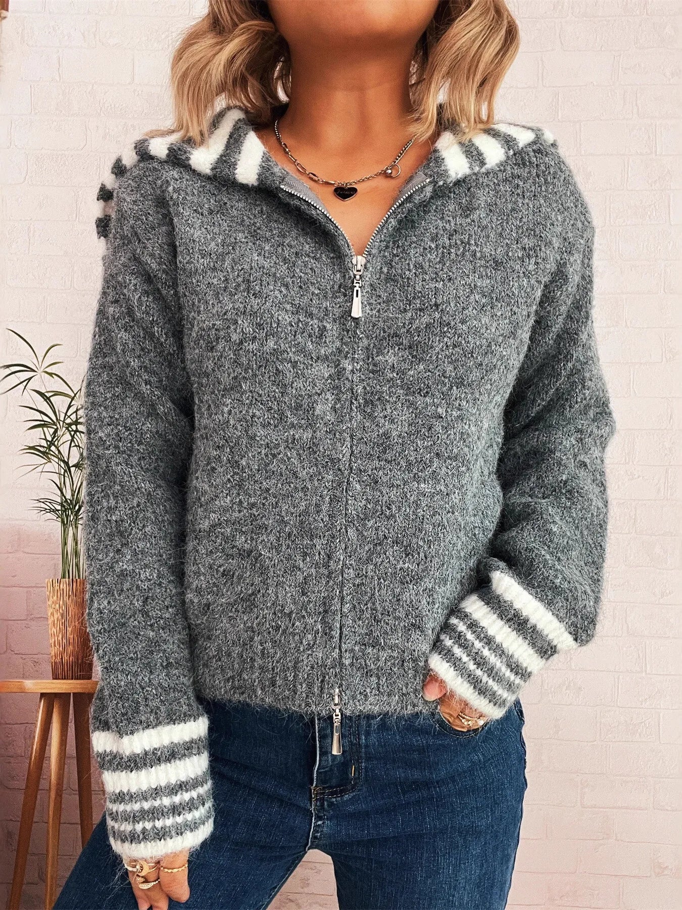 Gray zip-up cardigan with striped hood and ribbed striped cuffs, front zipper