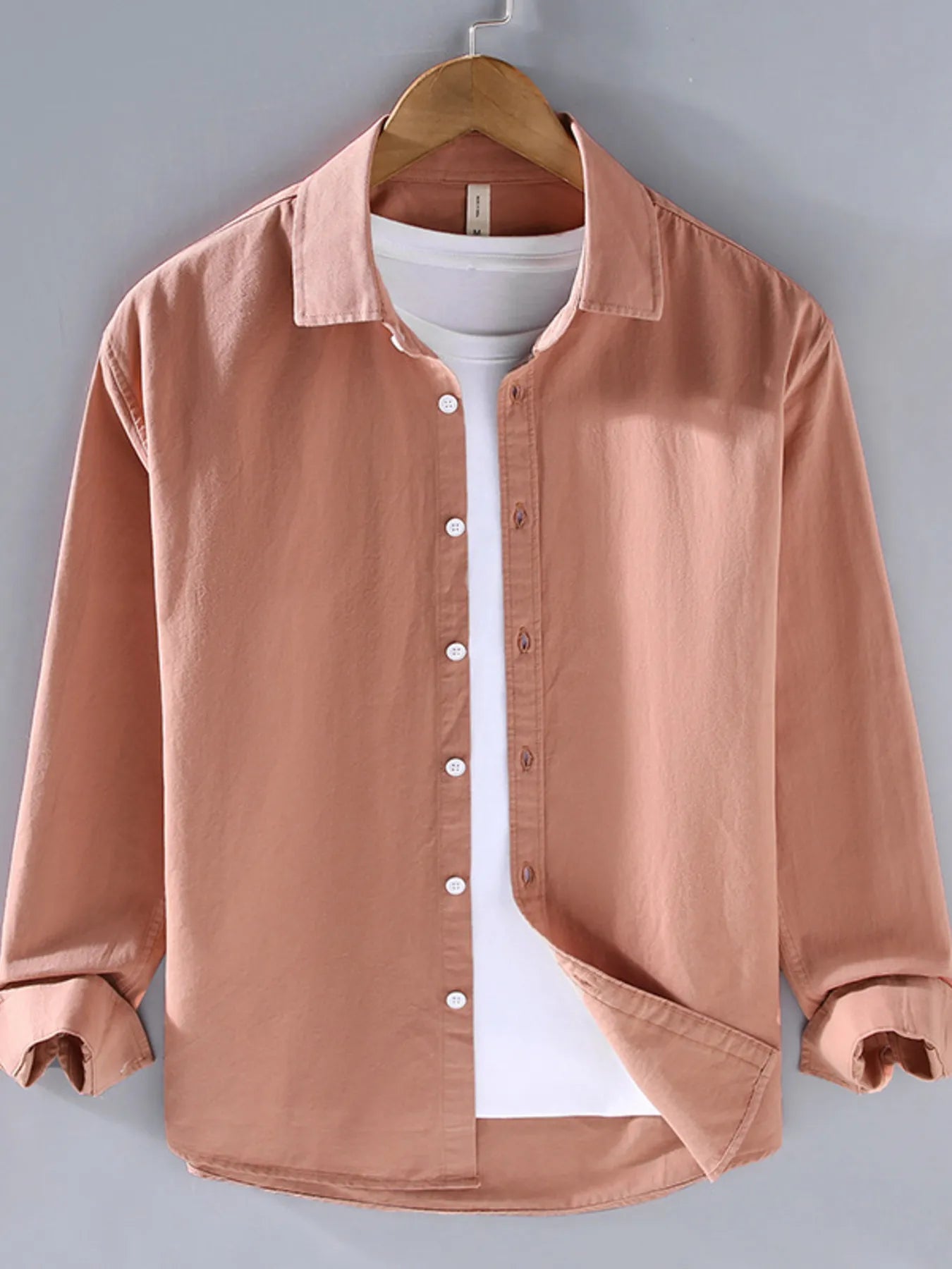 Apricot button-up long sleeve shirt with pointed collar and front button placket.