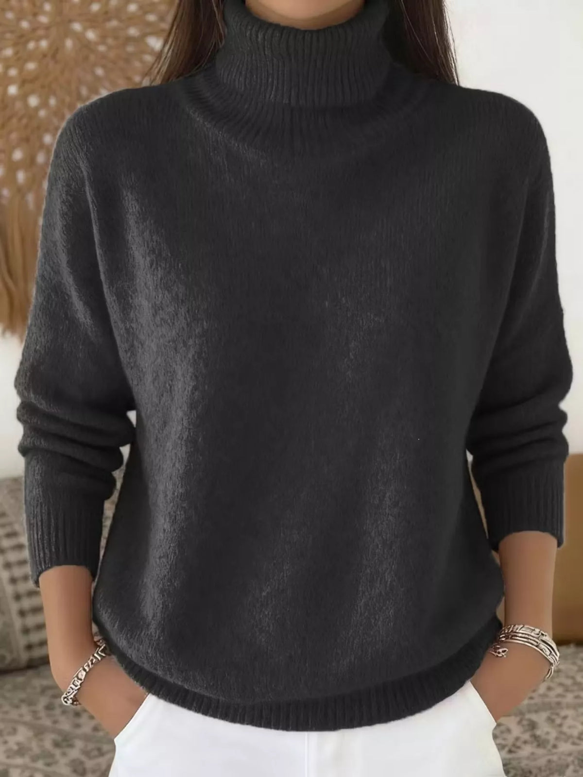 Black long-sleeve turtleneck sweater with ribbed collar, cuffs, and hem.