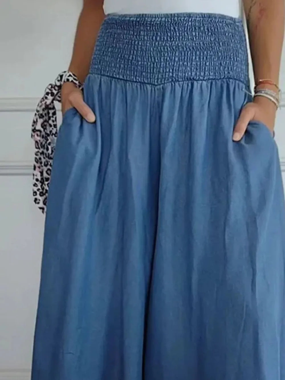Dusty blue smocked wide-leg pants with elastic waistband and relaxed drape