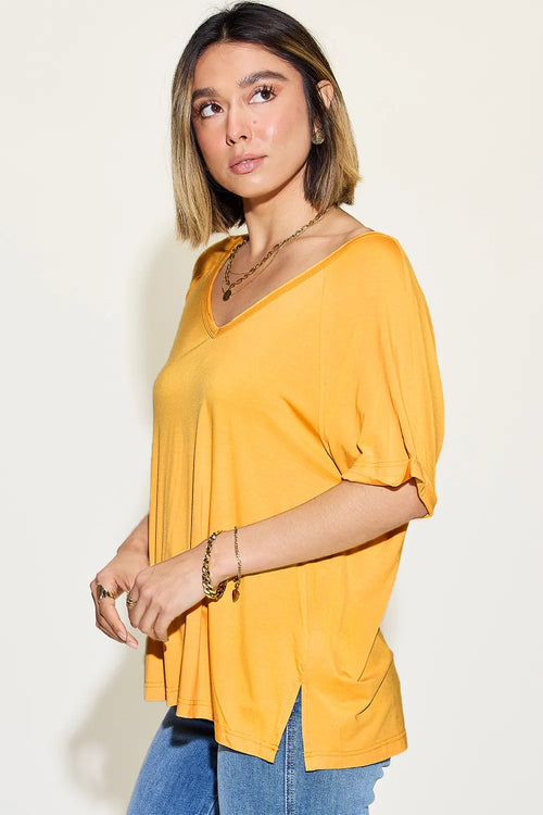 Gold V-neck short-sleeve t-shirt with side slit, draped loose fit.