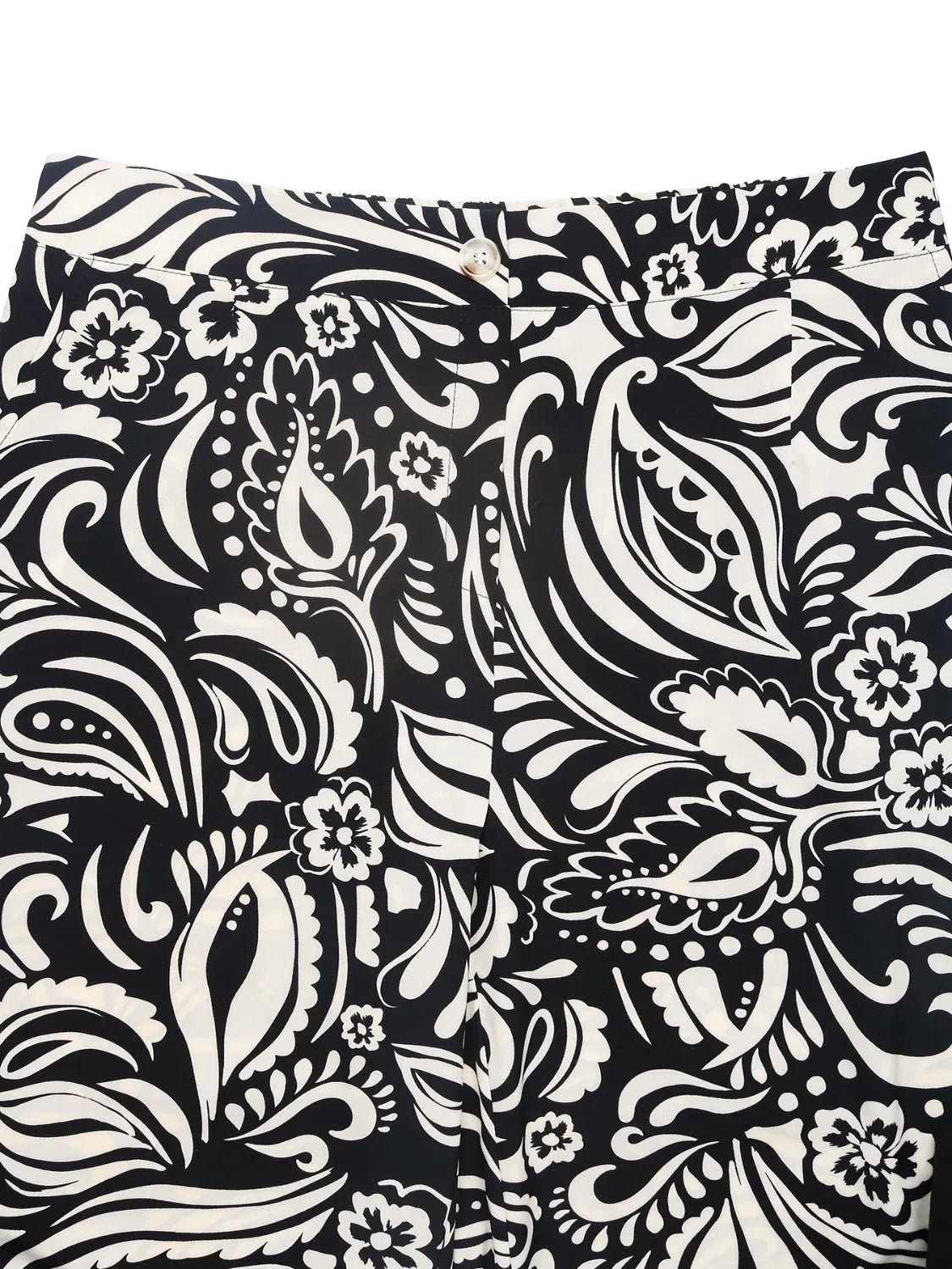 Close-up of wide-leg pants waistband area with black and white paisley floral print