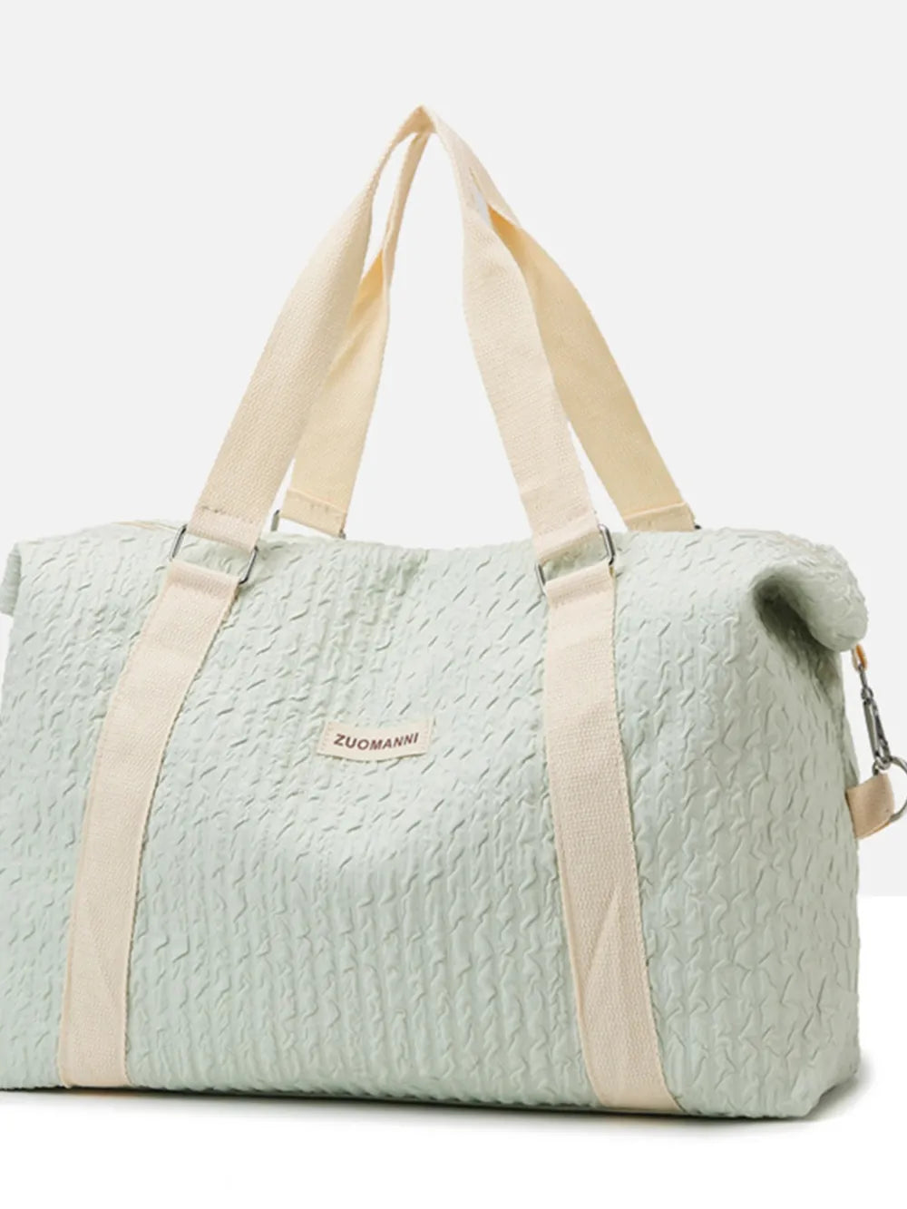 Light mint textured large duffle travel bag with beige straps and top handles