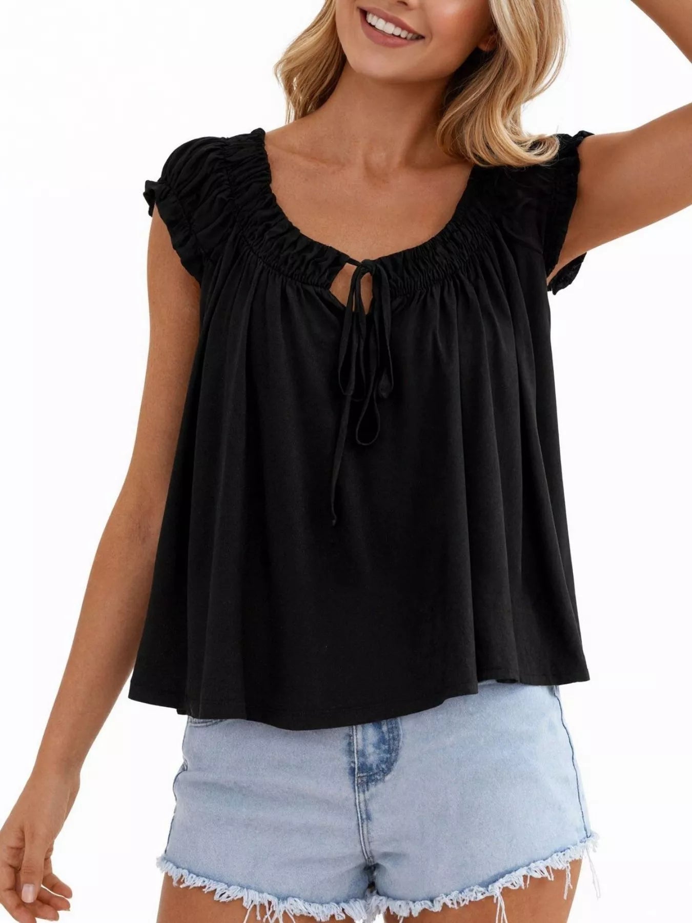 Black tie-front blouse with ruffled shoulders and center drawstring tie at neckline