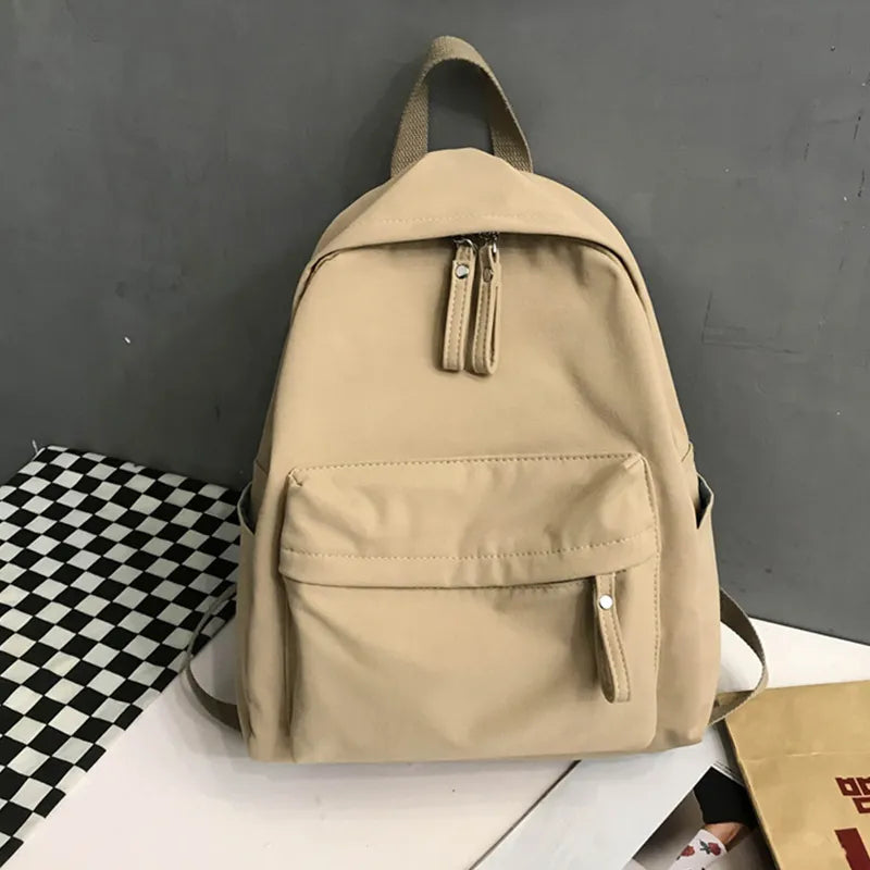 Ivory cotton zip backpack with drawstring zipper pulls and front zip pocket
