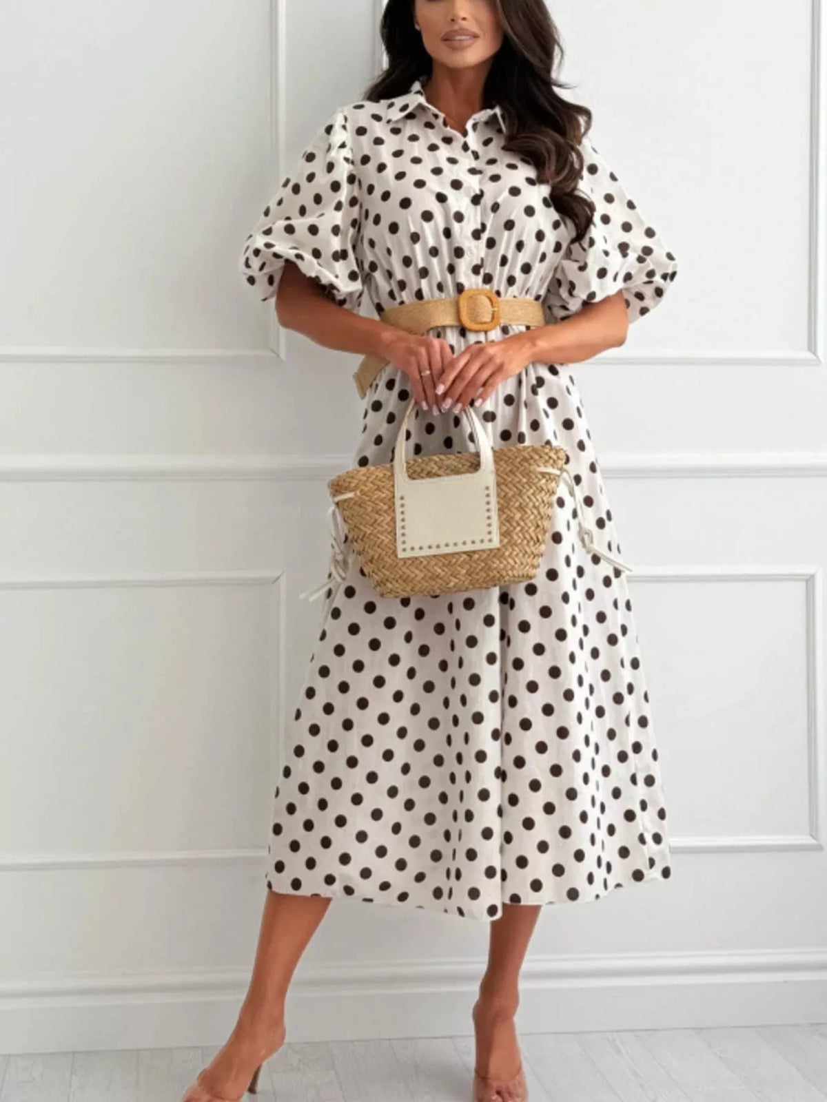 White polka-dot puff-sleeve midi dress with button front and tan waist belt.