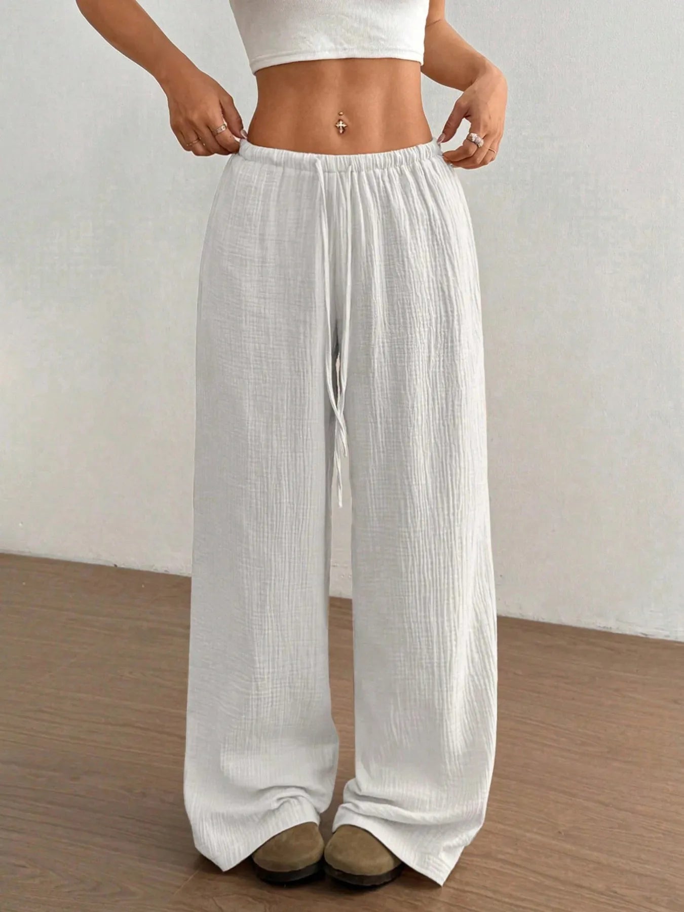 White wide-leg pants with elastic waistband and drawstring, front view.