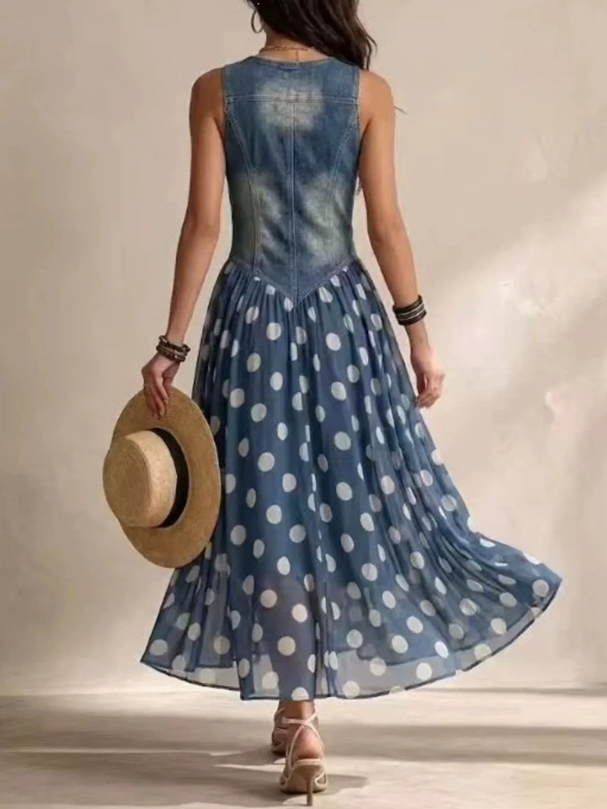 Blue polka dot sleeveless maxi dress, open-back style with V-neck and button details