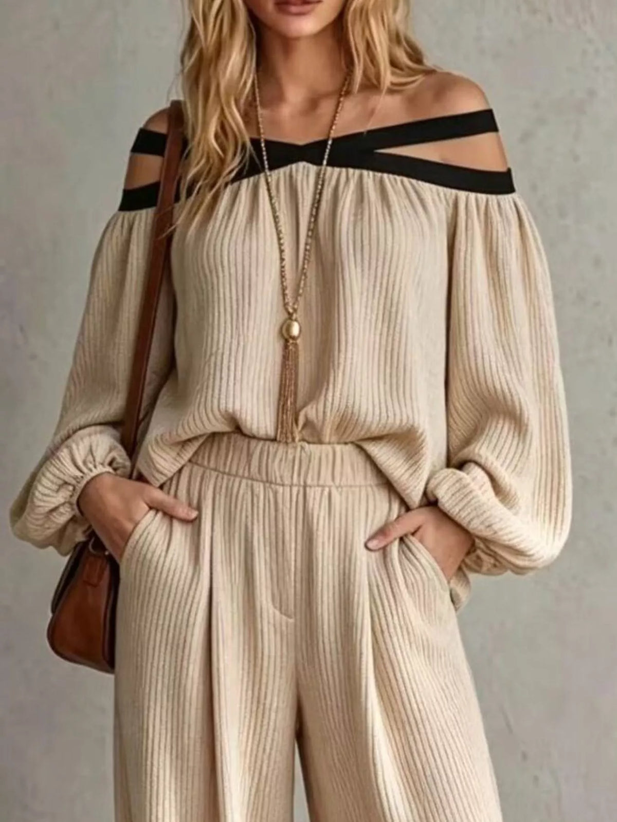Beige off-shoulder ribbed knit top with cutout strap neckline and wide-leg pants