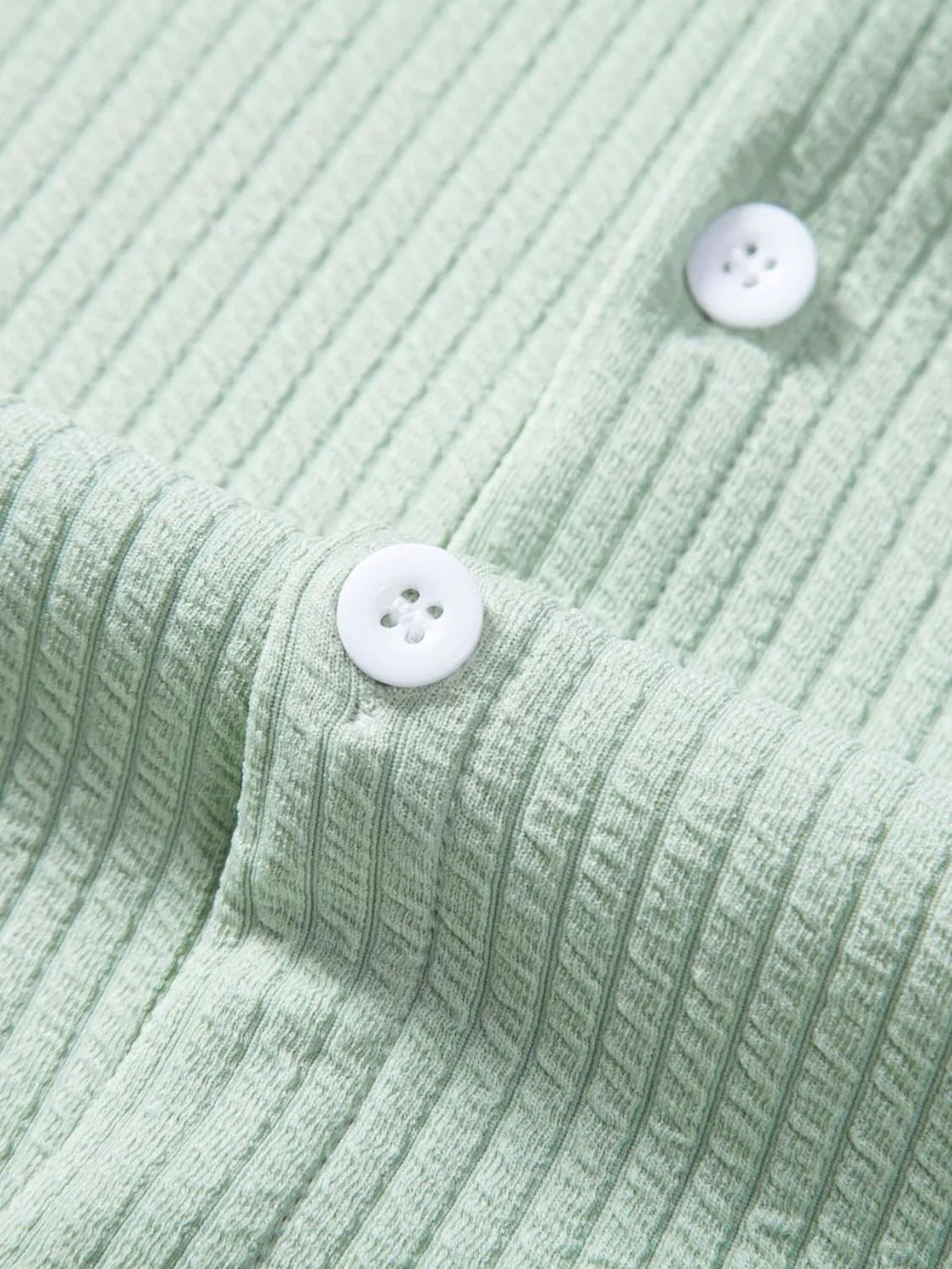 Mint green ribbed shirt with round white buttons