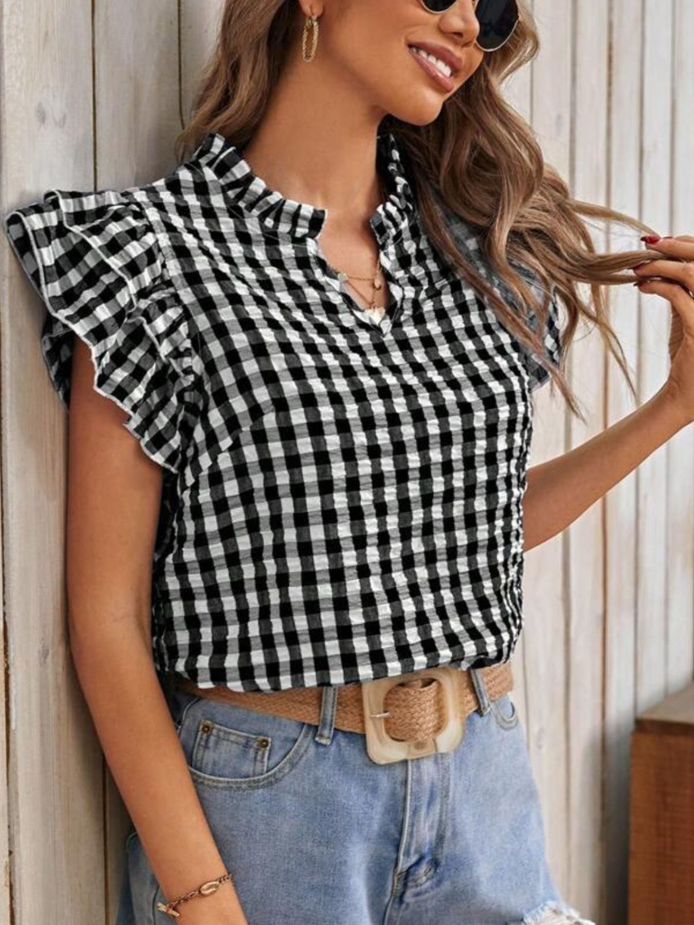 Gingham ruffle-sleeve blouse, black and white, shown with light-wash jeans