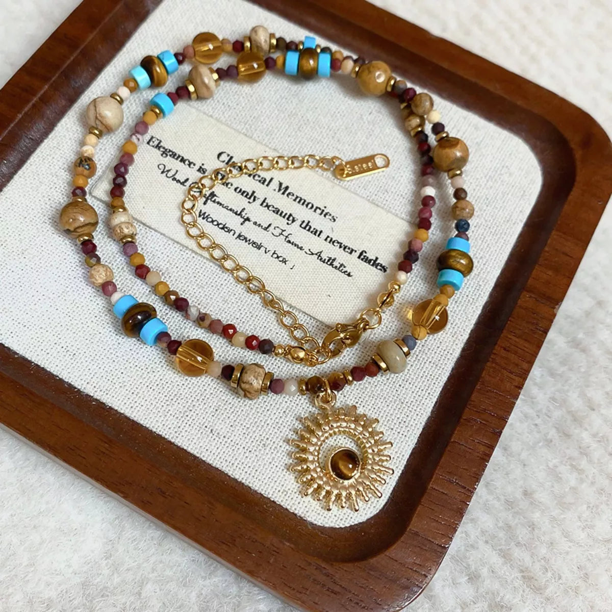 Multicolor beaded sunflower pendant necklace with gold-tone chain and charm details
