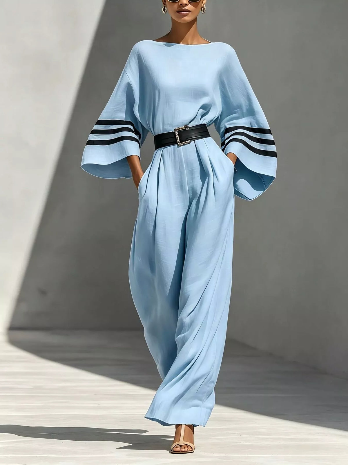 Light blue wide-sleeve jumpsuit with striped cuffs and black waist belt