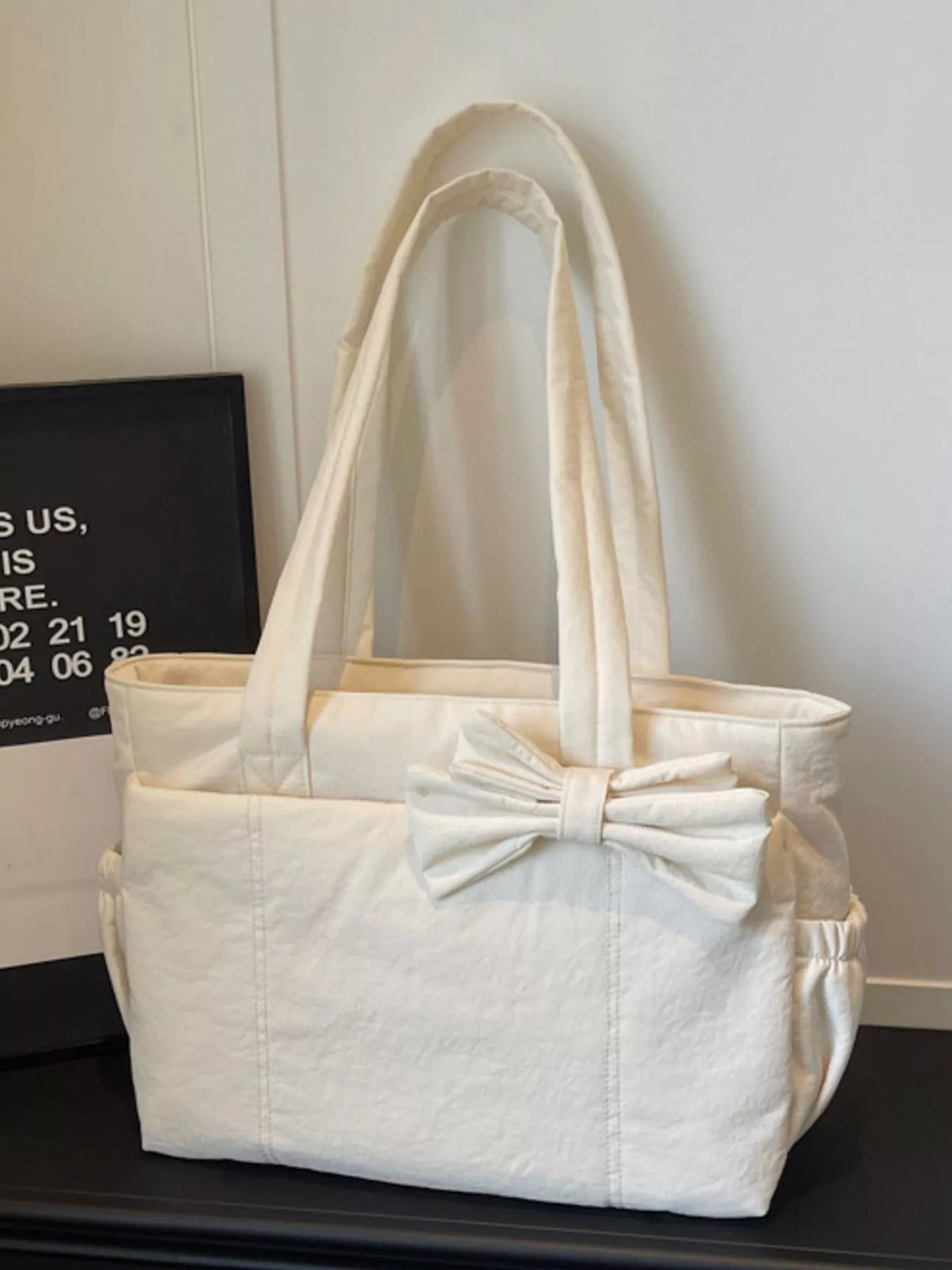 Ivory medium casual tote bag with large front bow and wide top handles