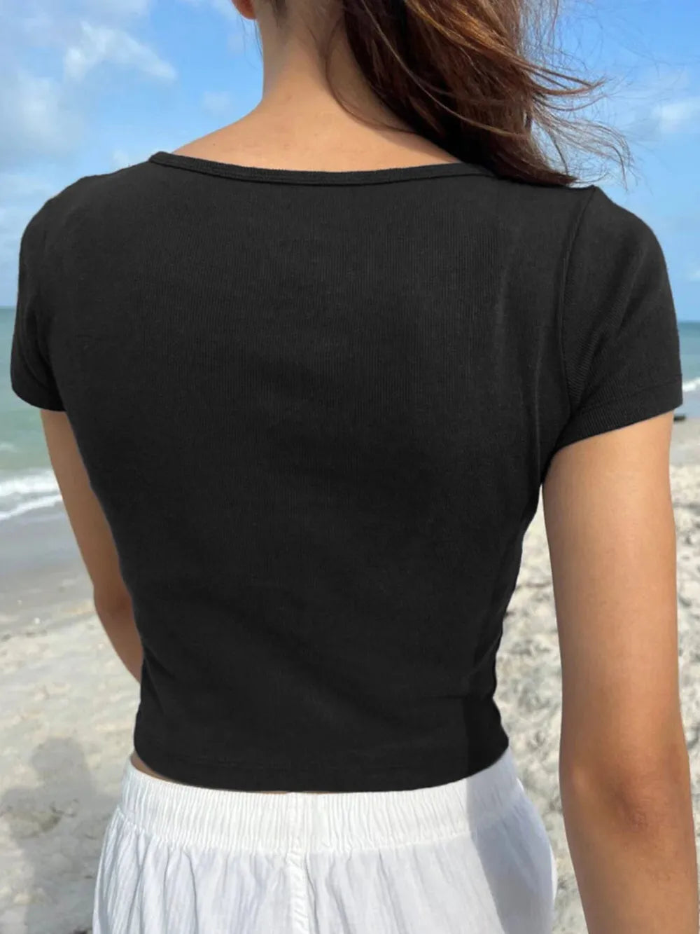 Black button-detail short-sleeve T-shirt, back view with ribbed crew neck