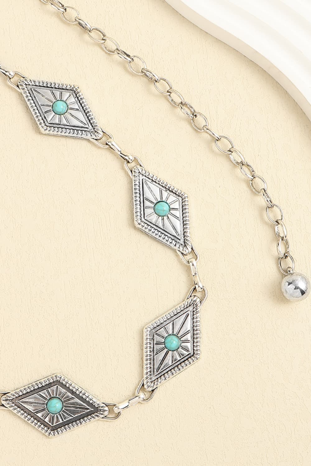 Turquoise diamond motif chain belt with scalloped bezels and silver-toned links
