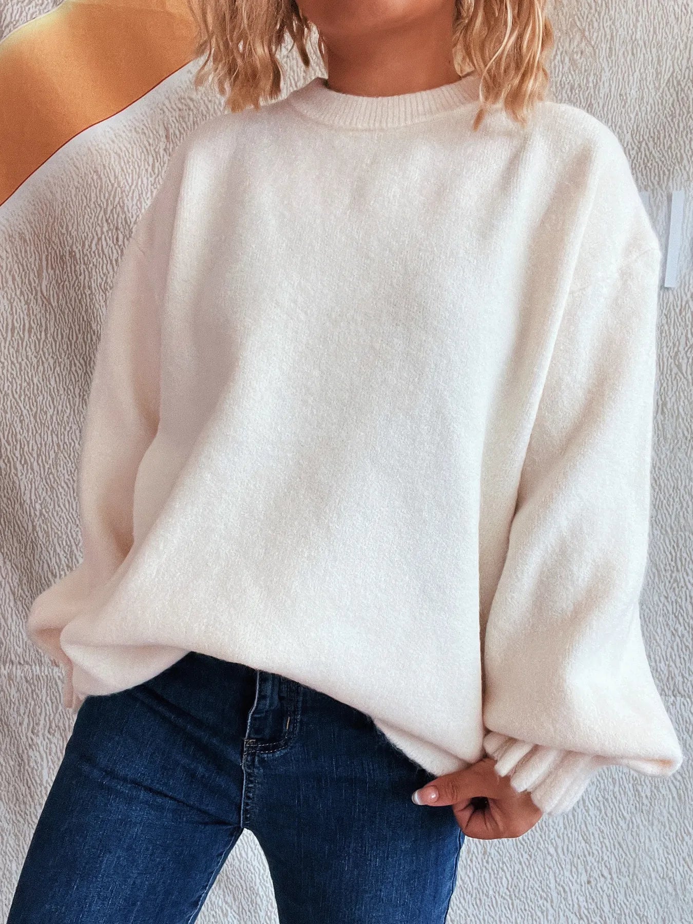 White dropped shoulder sweater with round neck and ribbed cuffs, relaxed silhouette