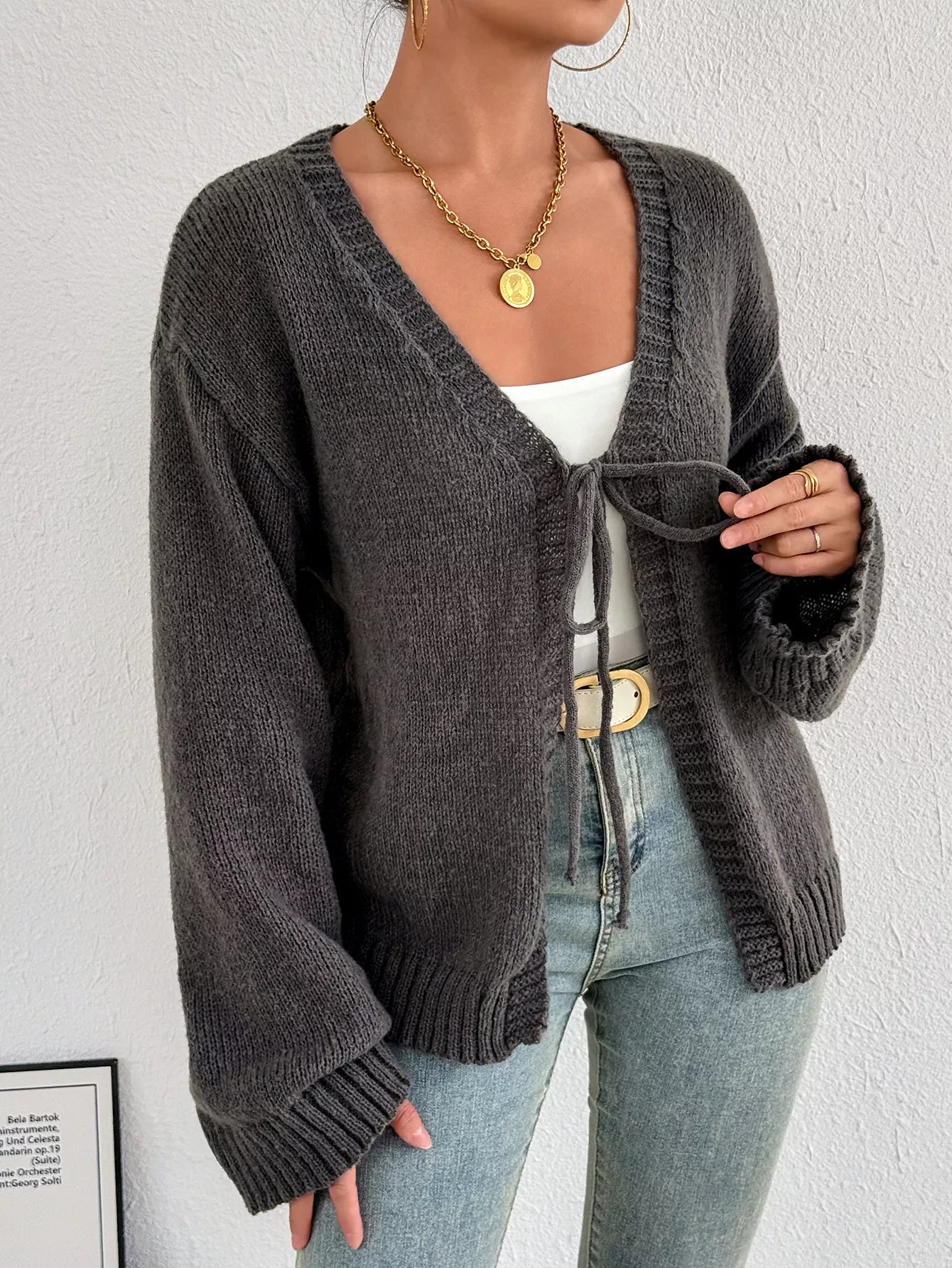 Dark gray tie-front cardigan with dropped shoulders and ribbed cuffs, V-neck opening