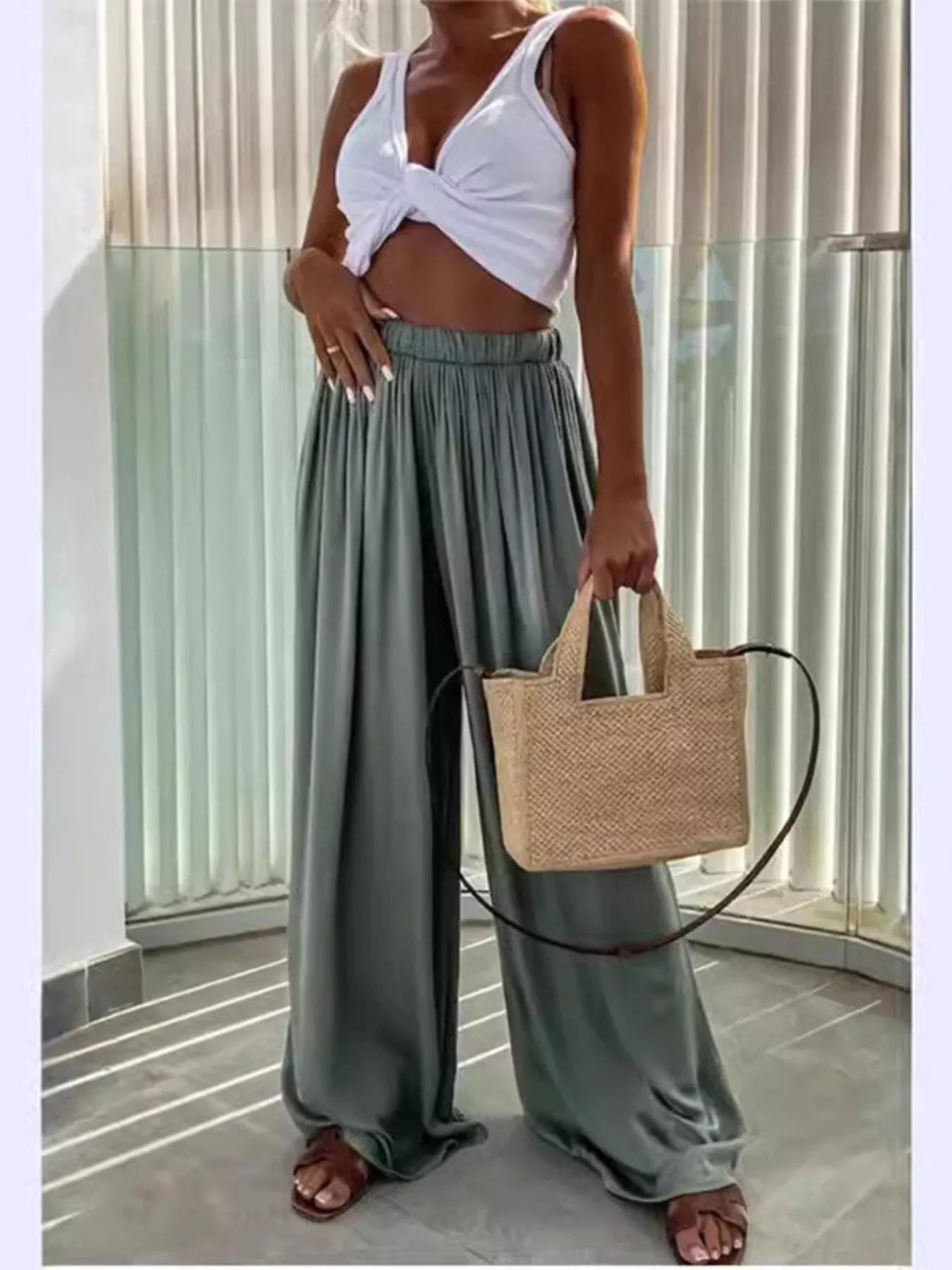 Sage green wide-leg flowy pants with gathered paper-bag waist and pleated front