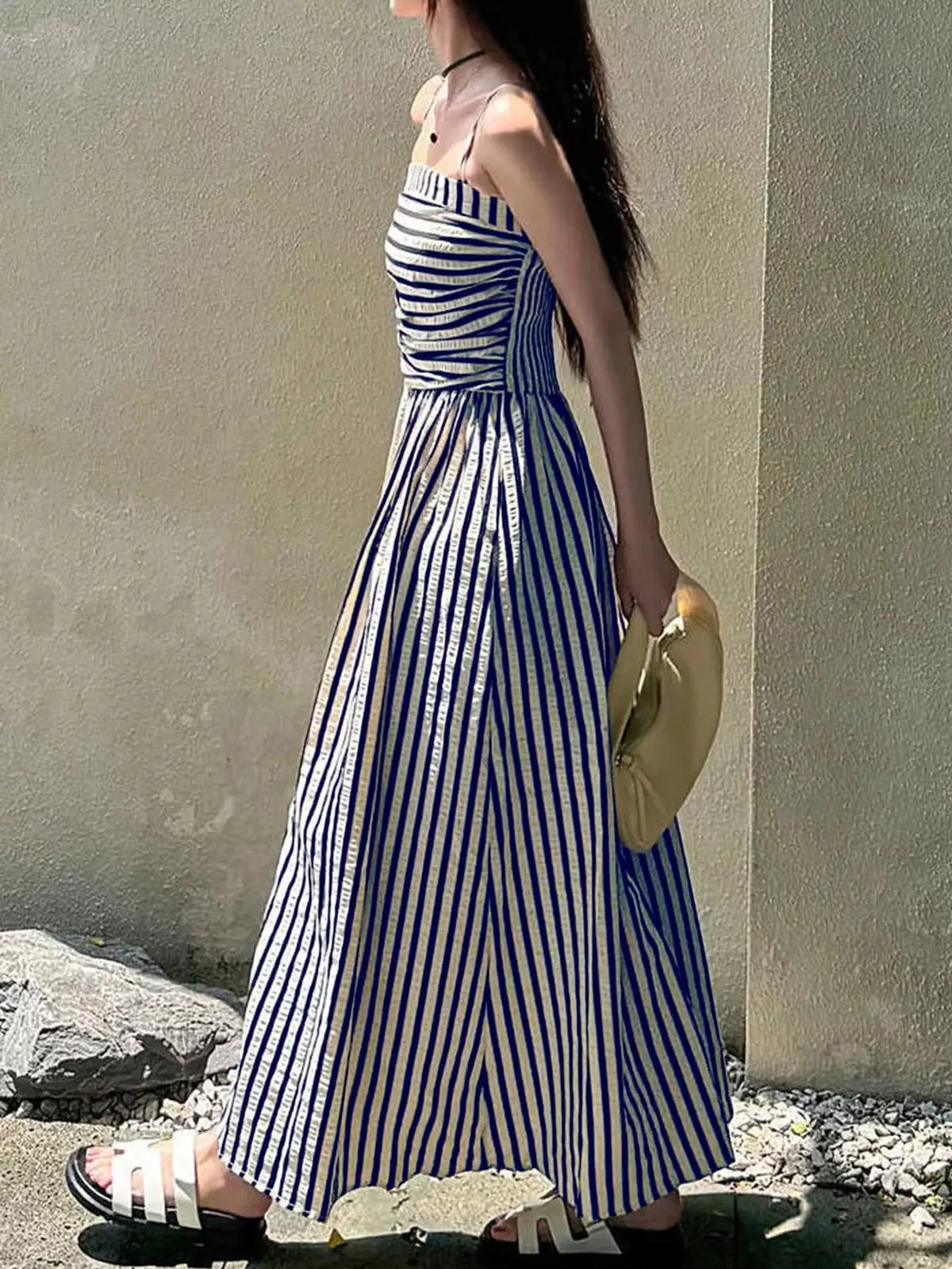 Ruched sleeveless blue-and-white striped maxi dress from side view