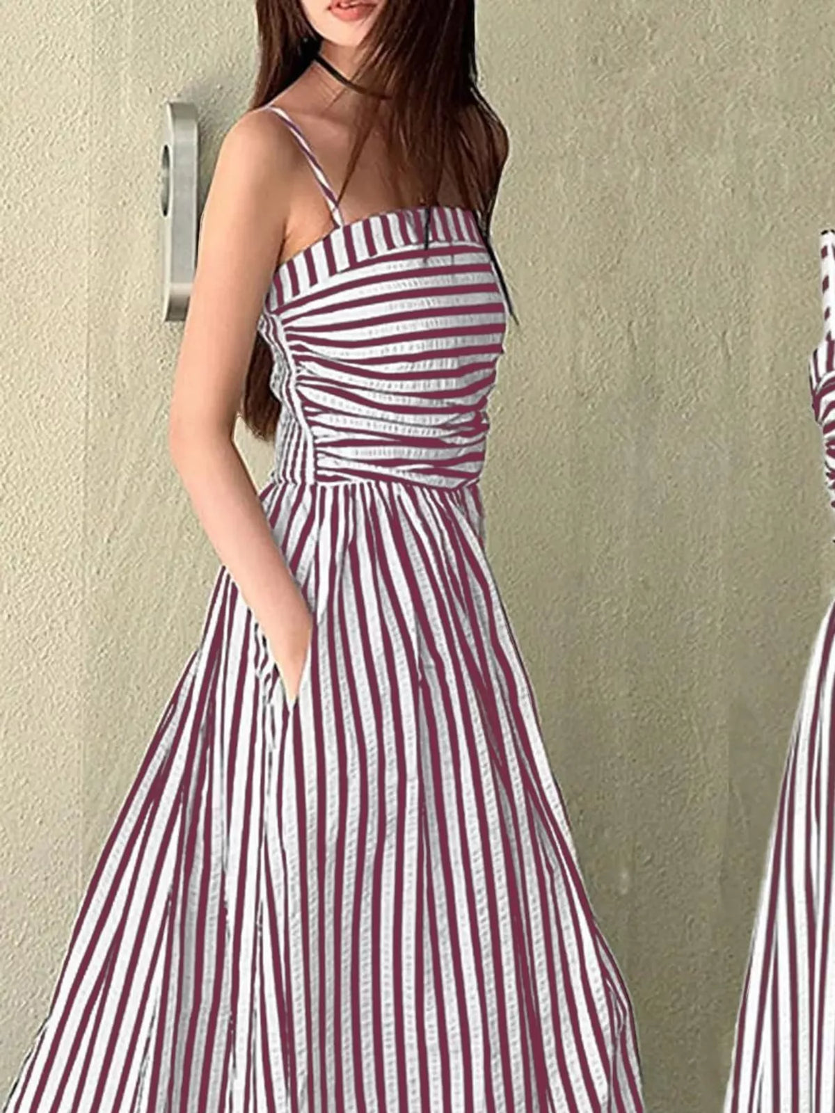 Ruched sleeveless maxi dress with pink-and-white vertical stripes, fitted bodice