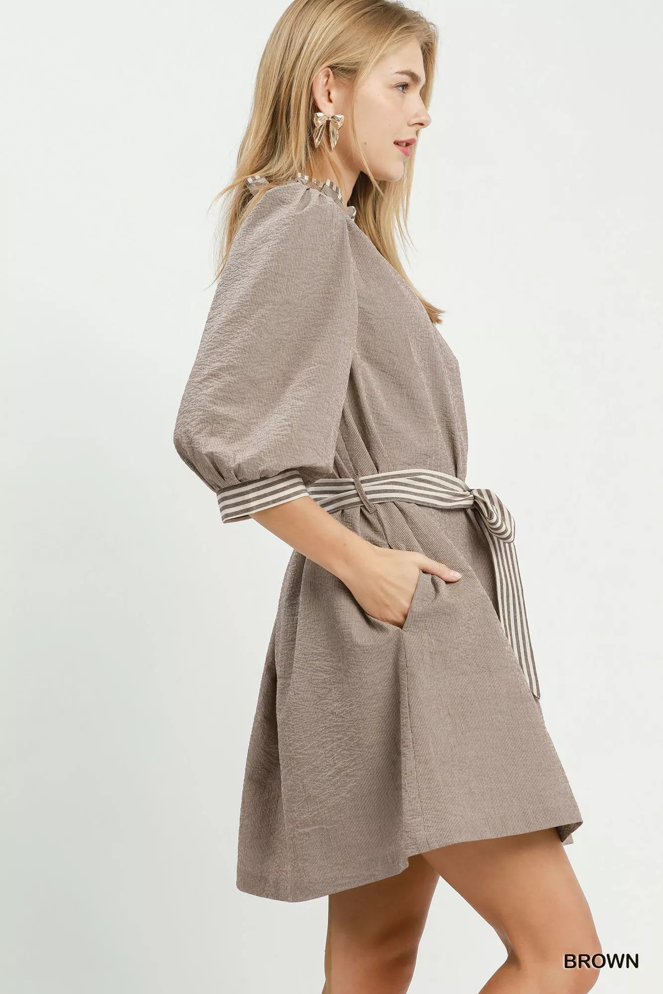 Brown textured mini dress, side view; tie waist belt and striped contrast cuff trim