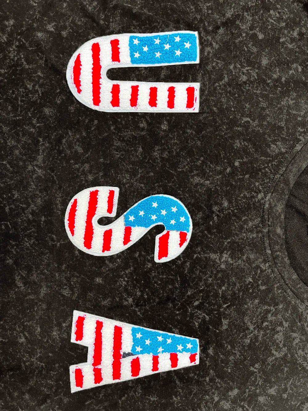 Dark round neck short sleeve T-shirt close-up of USA flag letter graphics