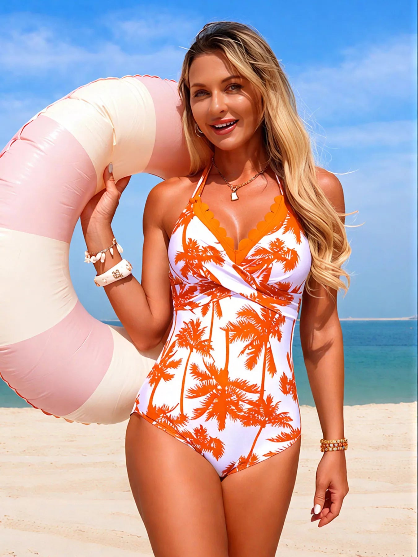 Tropical palm print halter-neck one-piece swimsuit by Trendsi, orange palm pattern with tied chest detail.