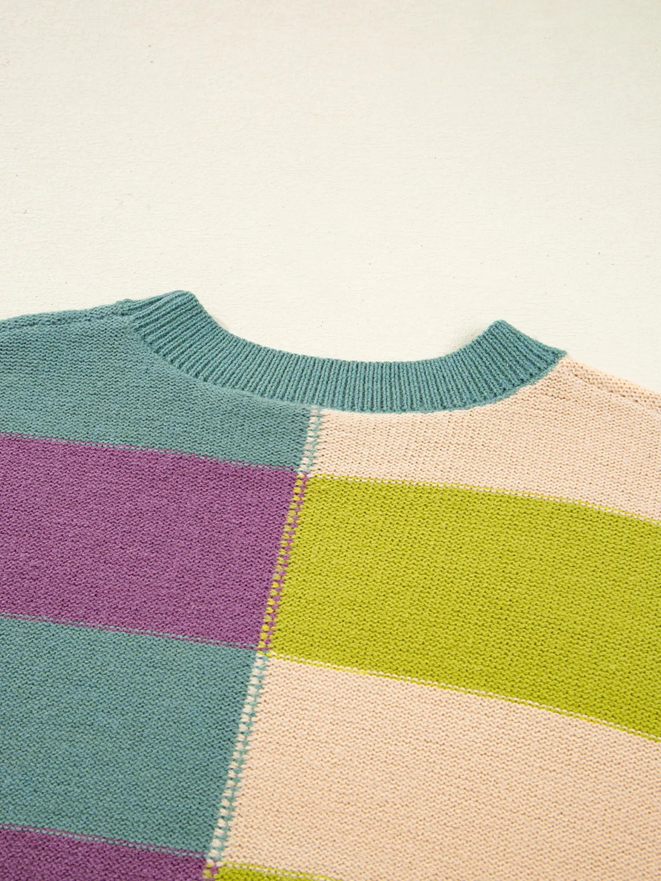 Multicolor block stripes with ribbed knit collar detail on the sweater