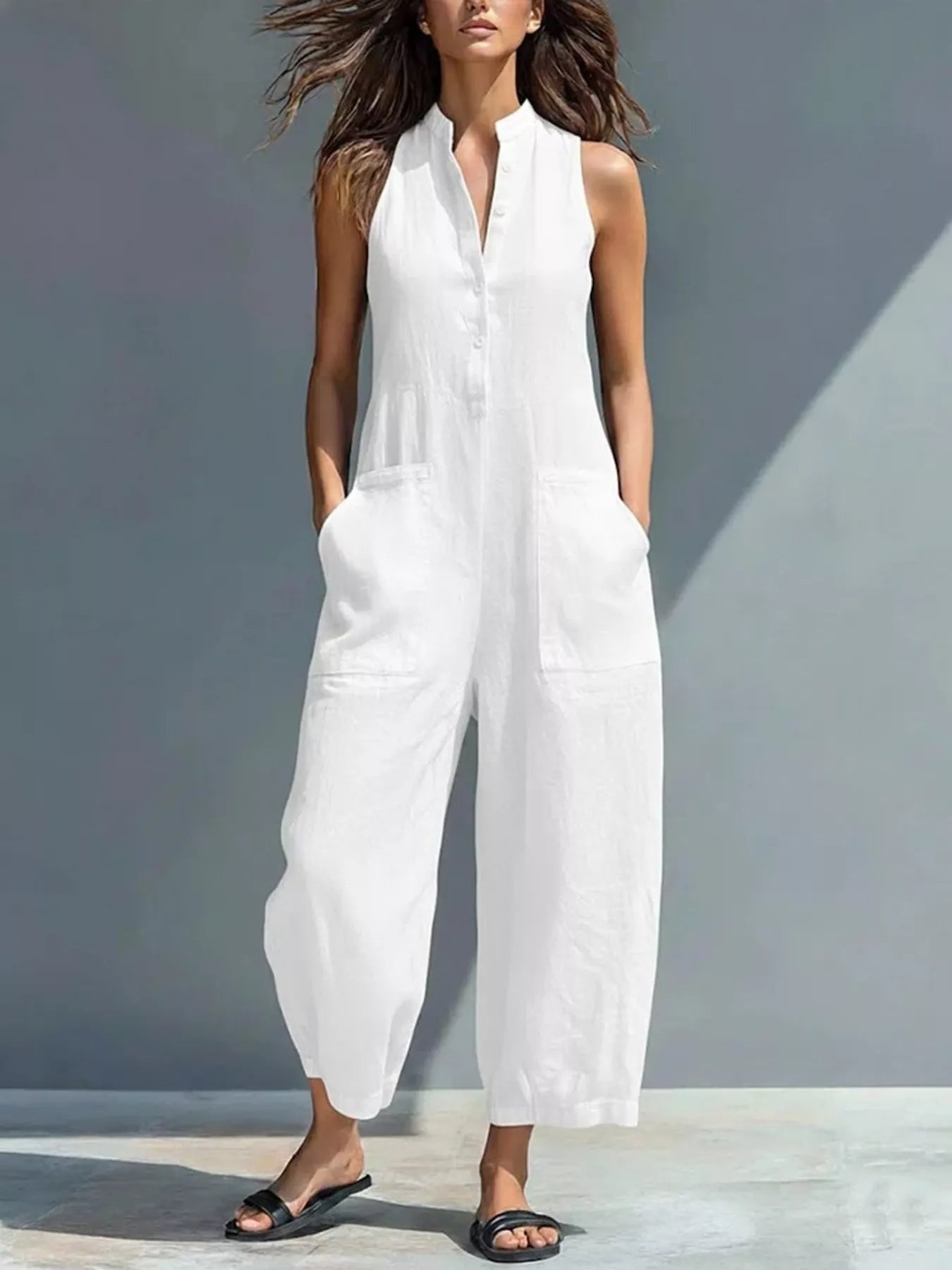 White sleeveless button-front jumpsuit with patch pockets and wide cropped legs