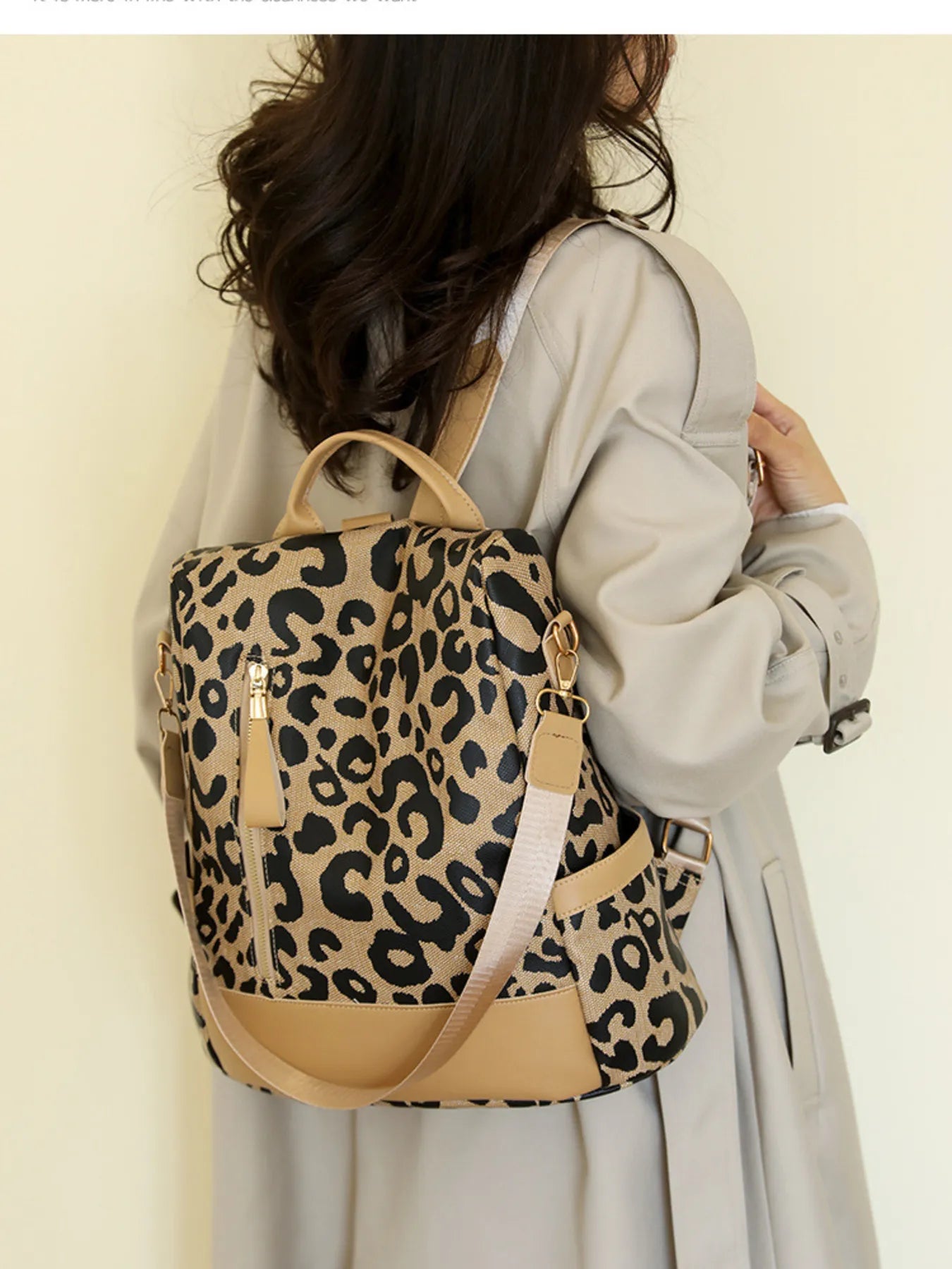 Leopard print backpack with tan body, black-and-tan pattern, and gold-tone buckles.