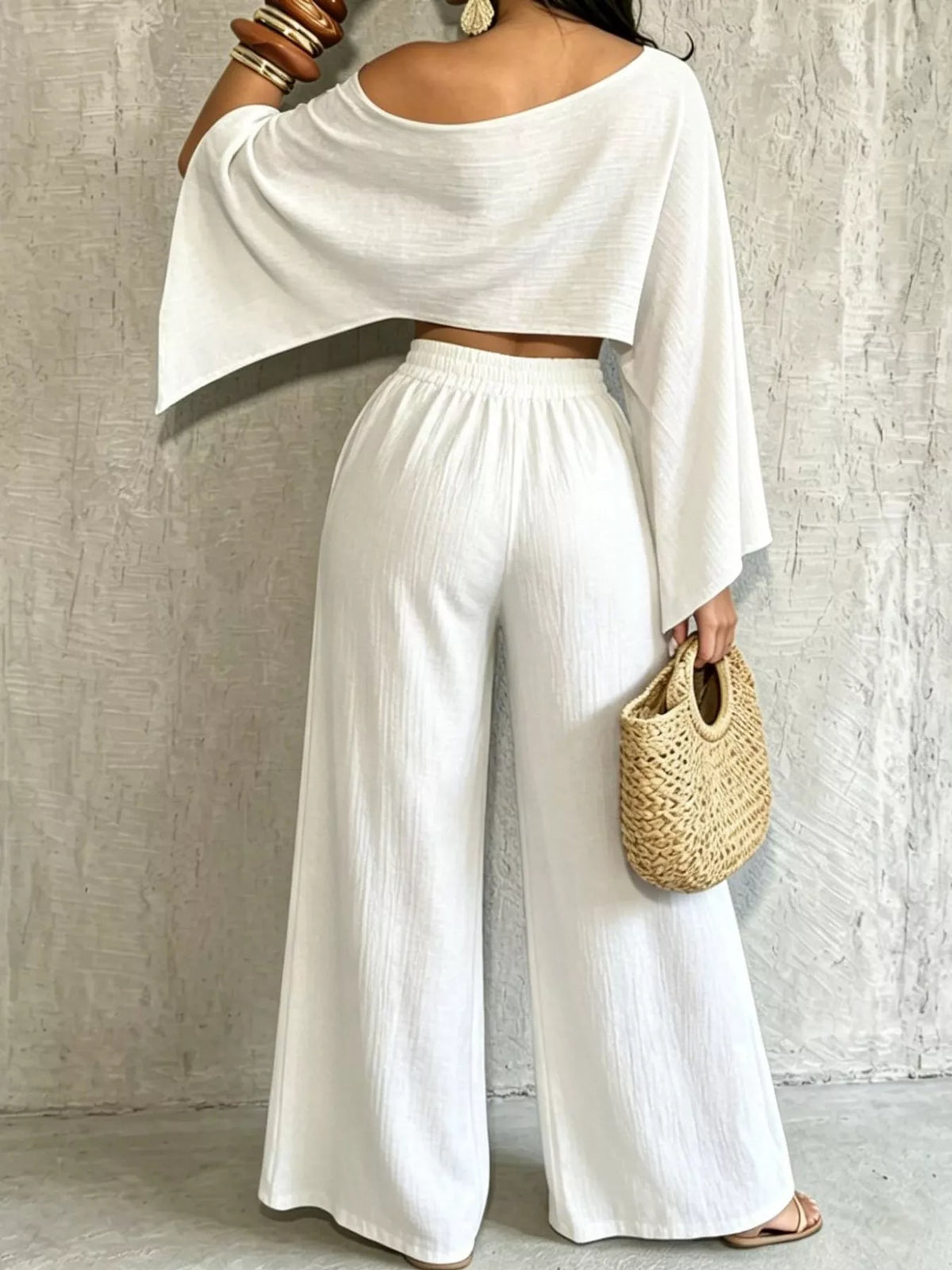White boat-neck crop top with wide-leg pants, loose draped sleeves