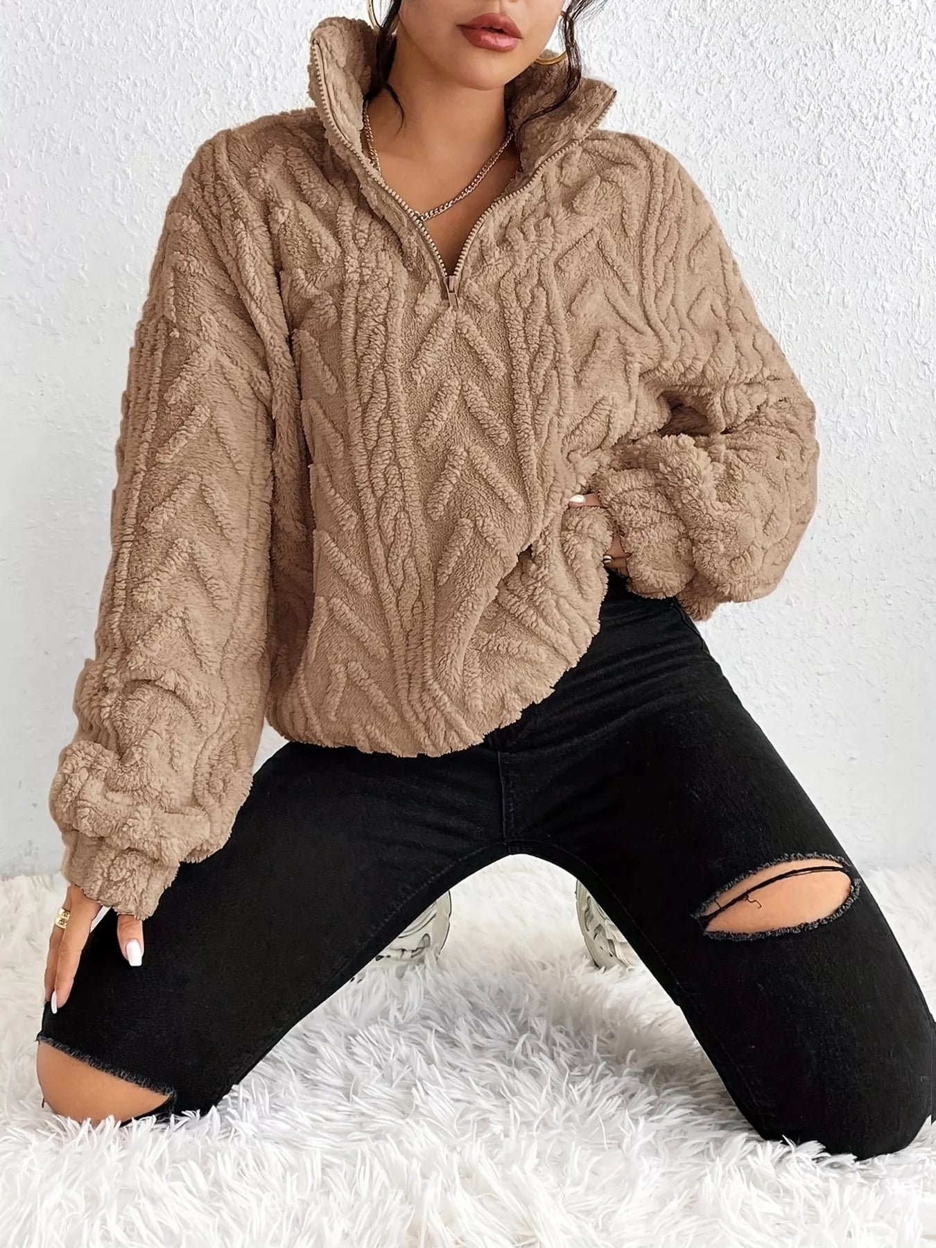 Apricot sherpa quarter-zip sweatshirt with cable knit texture and dropped shoulders