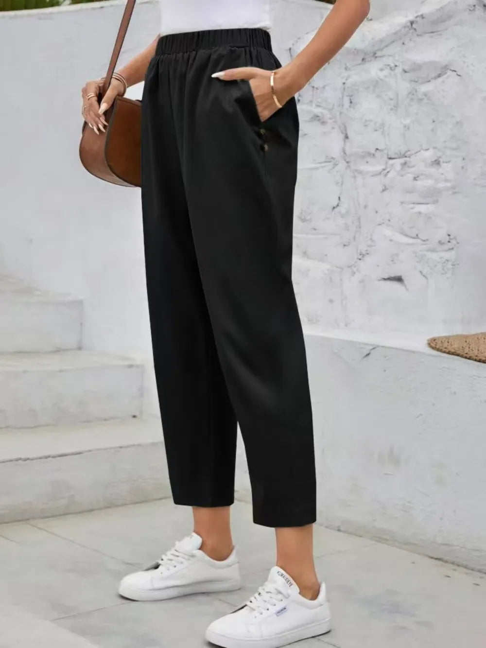 Black high-rise elastic waist pants with straight cropped leg and front drape