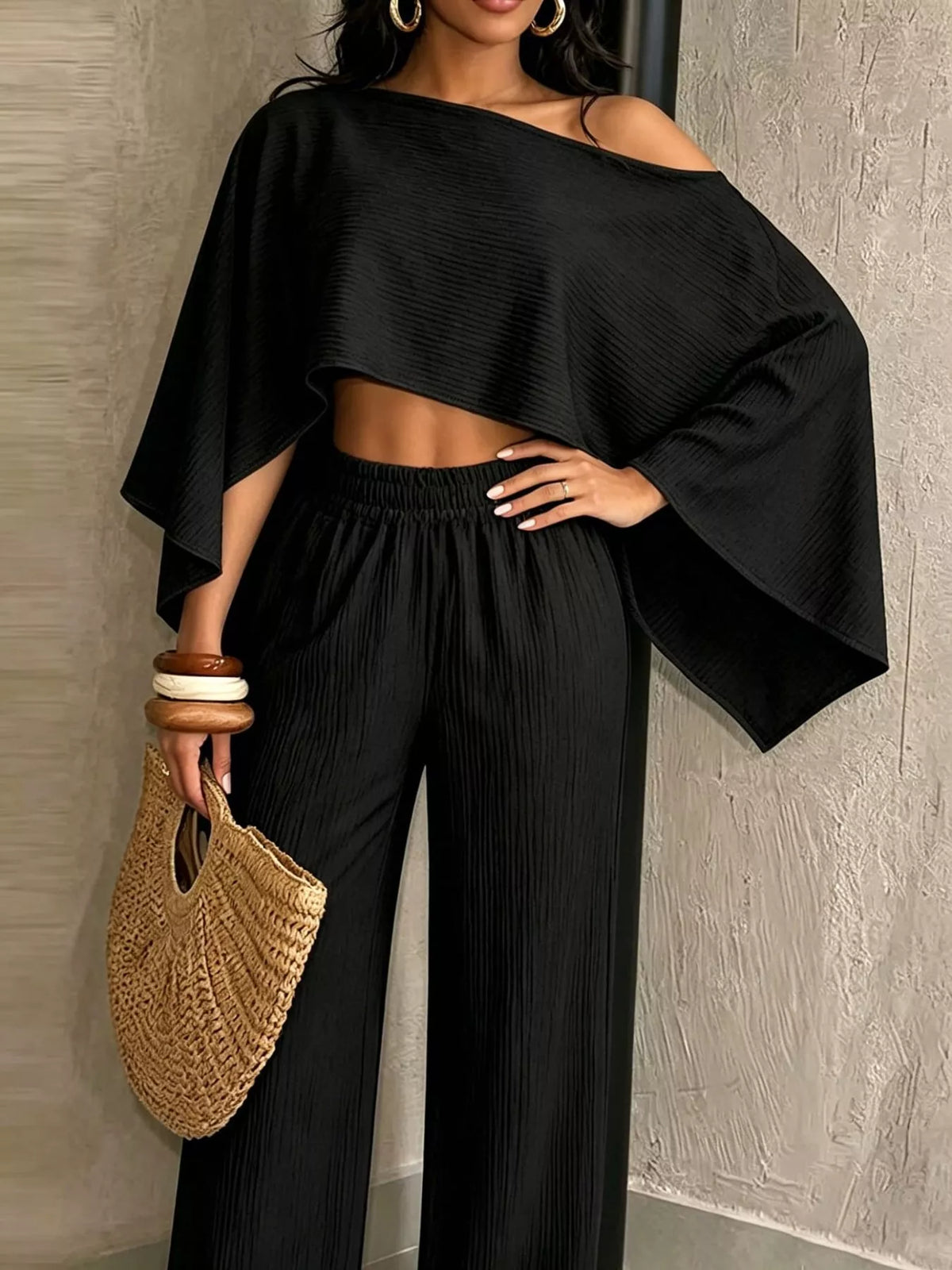 Black boat-neck crop top with dolman sleeves and matching wide-leg pants