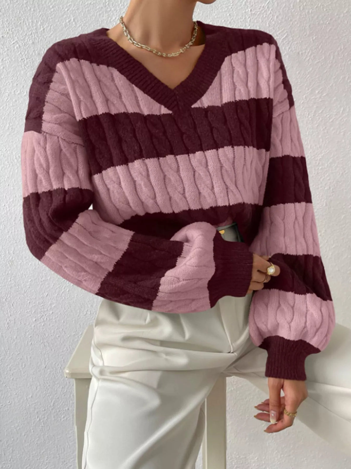 Mauve and pink striped cable knit V-neck sweater with long ribbed sleeves