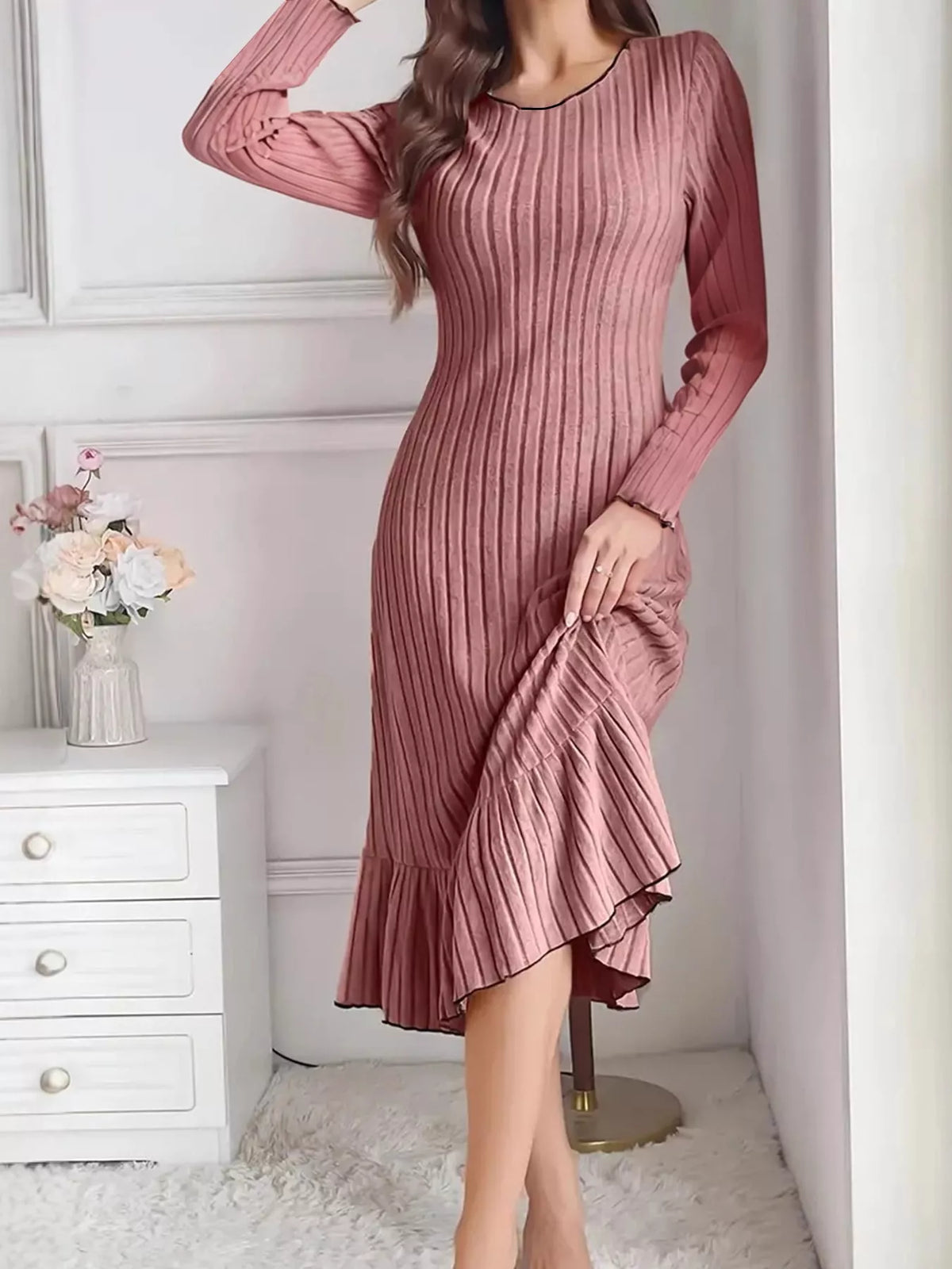 Dusty pink ribbed knit bodycon dress with long sleeves and ruffle hem