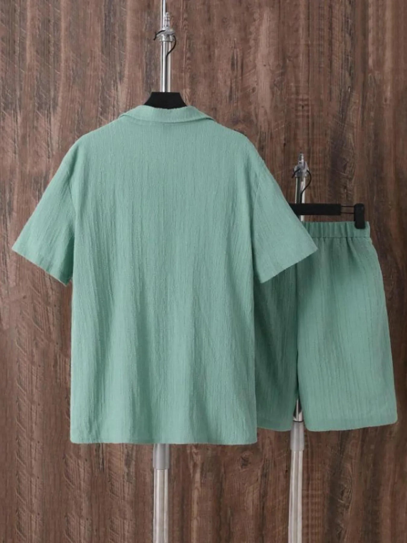 Back of men's plus size green short sleeve button-up shirt and matching shorts set