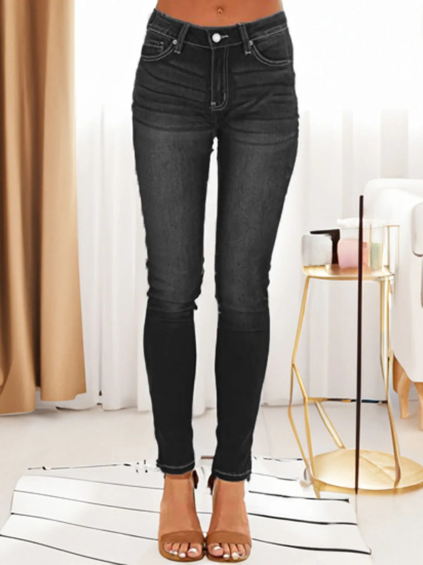 Black skinny fit washed jeans with button and zipper fly, five-pocket style.