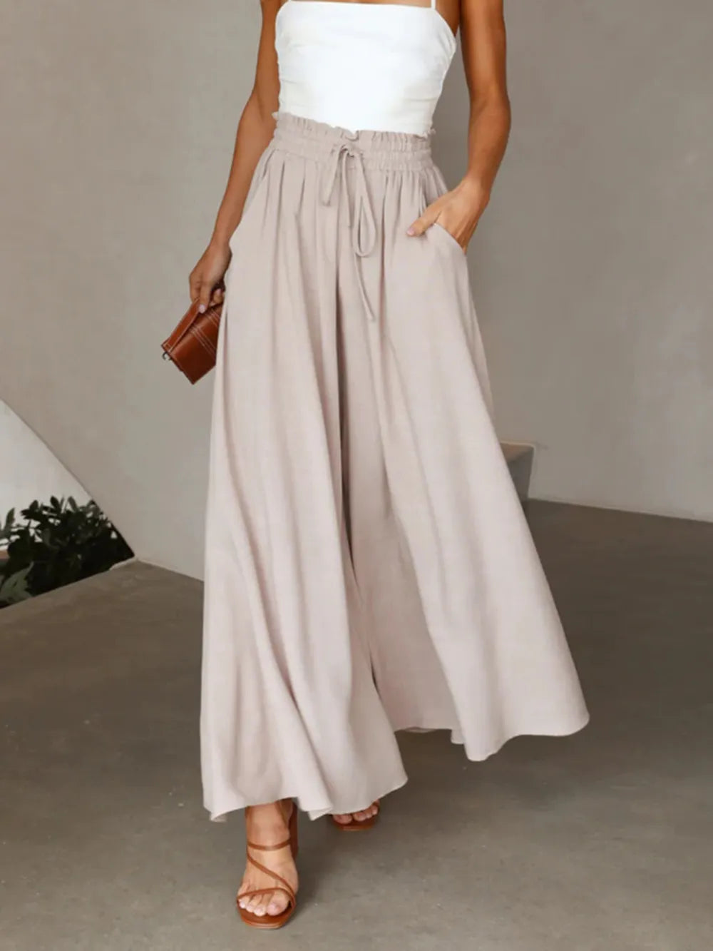 High-waist wide-leg pants in light gray with elastic drawstring waist and wide legs