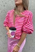 Hot pink striped round-neck long-sleeve sweatshirt with relaxed fit and cuffed sleeves.