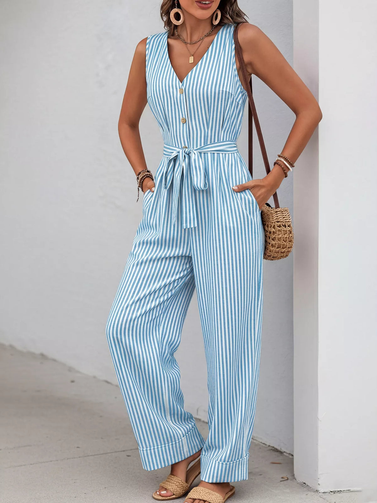 Striped sleeveless V-neck belted jumpsuit in light blue and white, button front, wide-leg