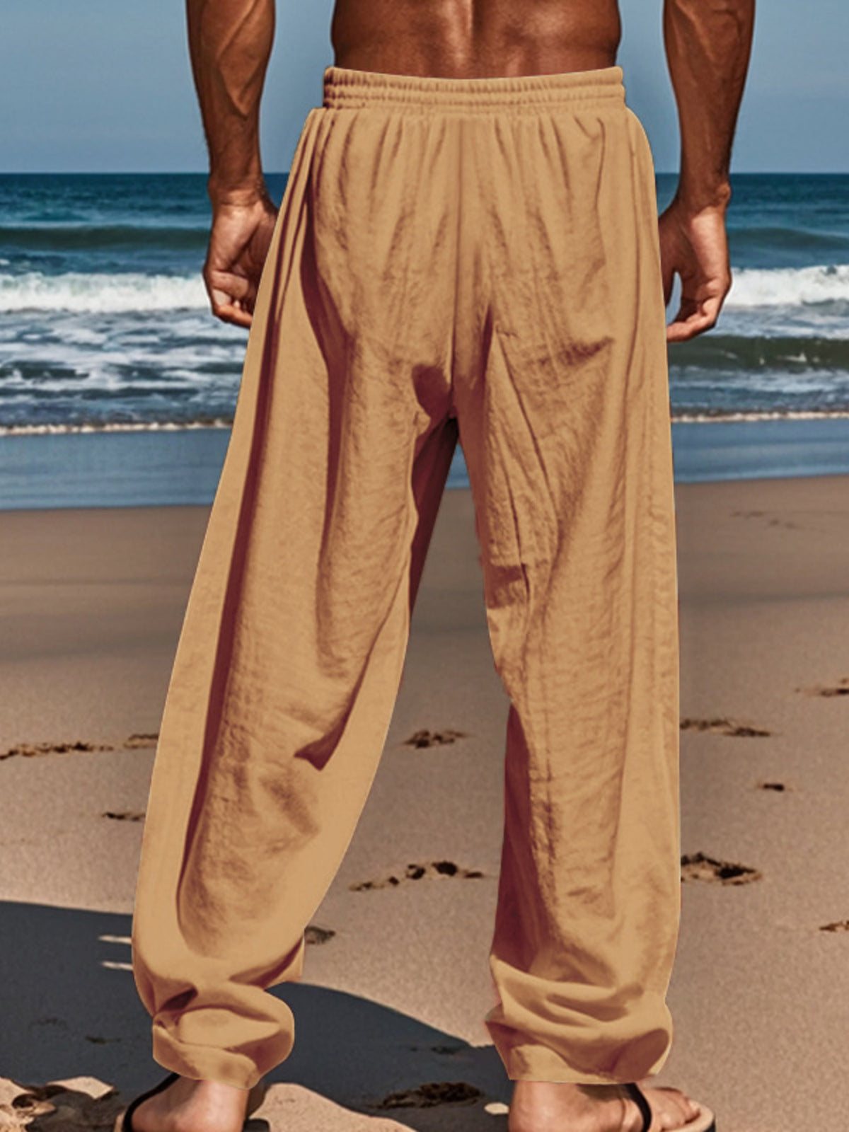 Tan drawstring pants with elastic waistband and relaxed straight-leg fit